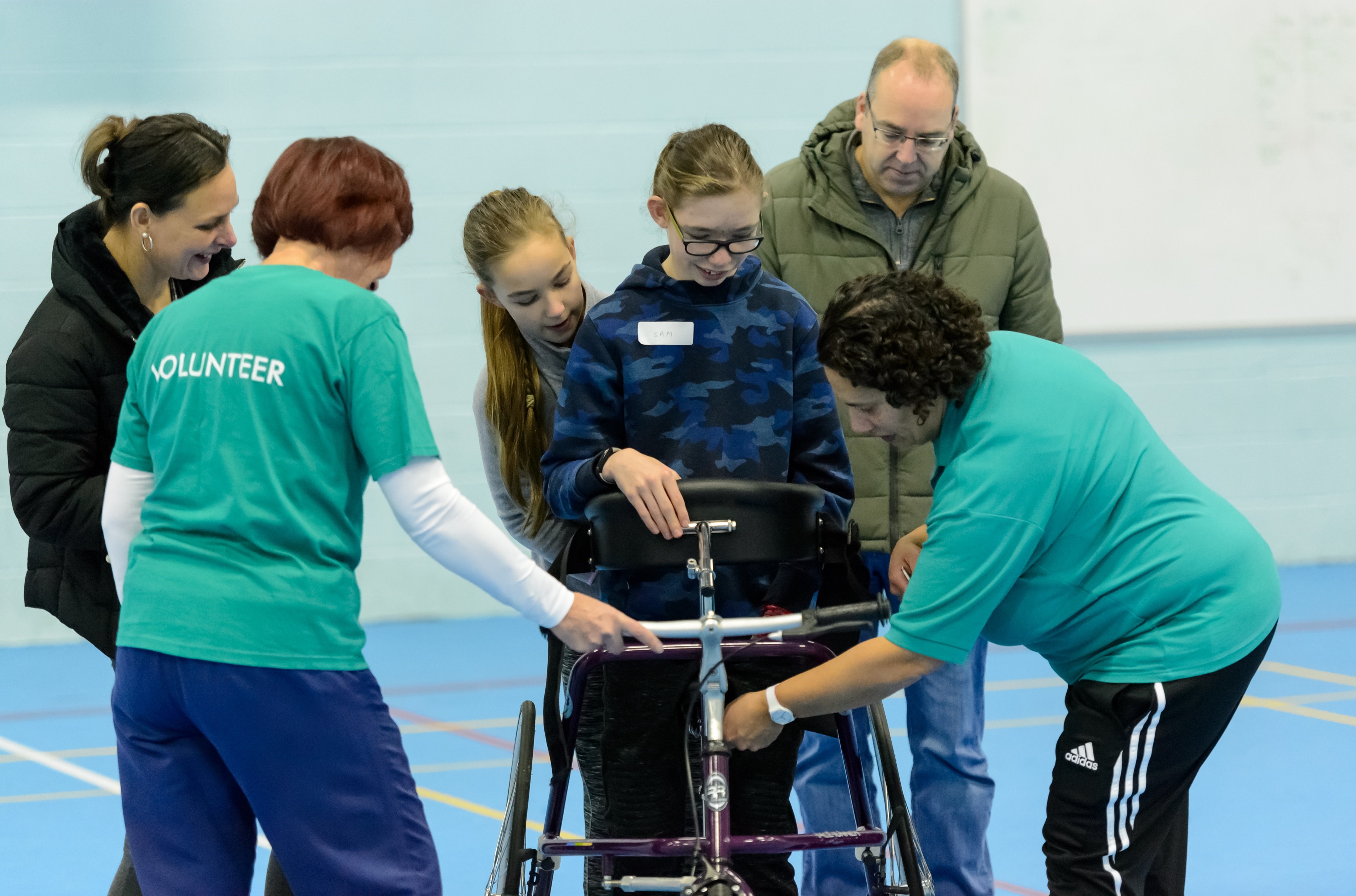 Volunteers supporting a disabled participant